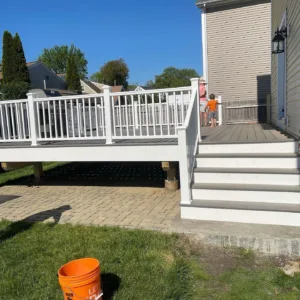 Deck service project showcasing a newly built deck with stairs and railing for outdoor living.