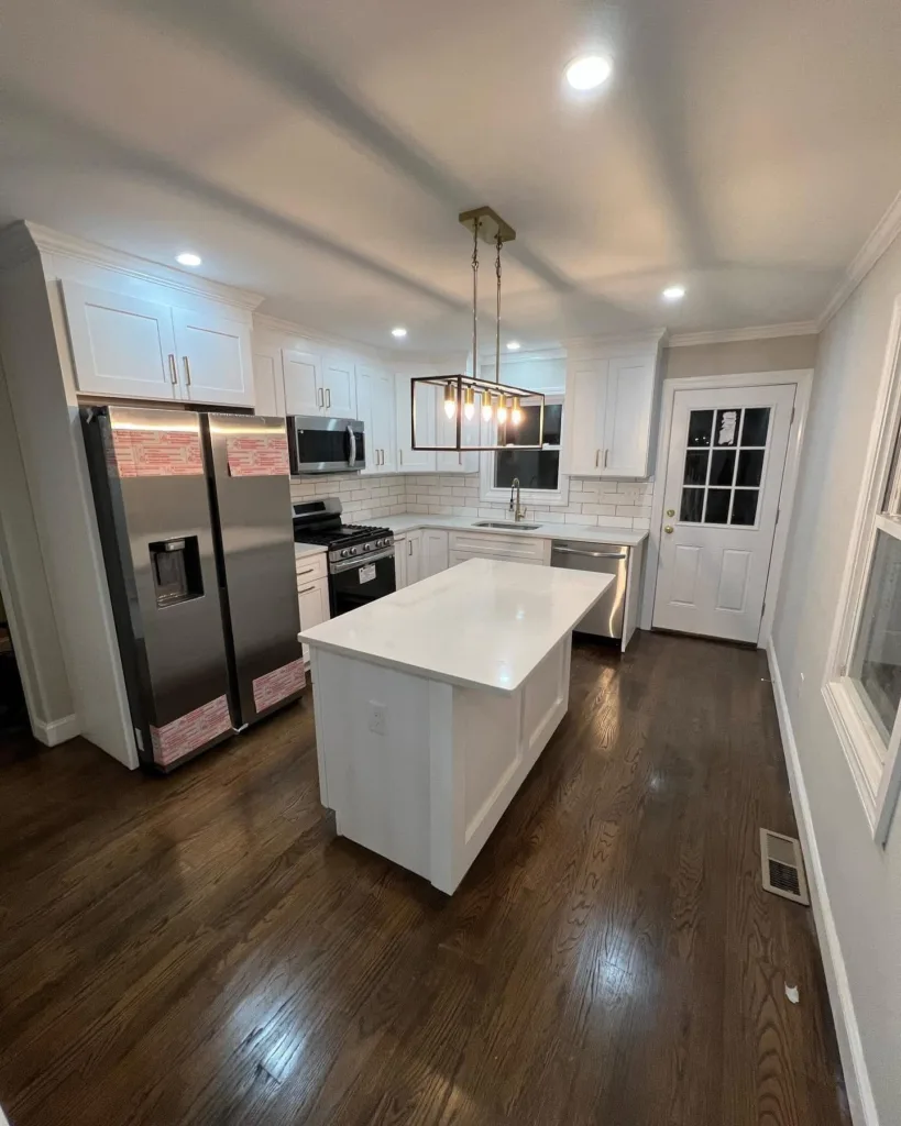 Kitchen remodeling and renovation project by Ribeiro Construction, showcasing modern cabinetry, appliances, and lighting.