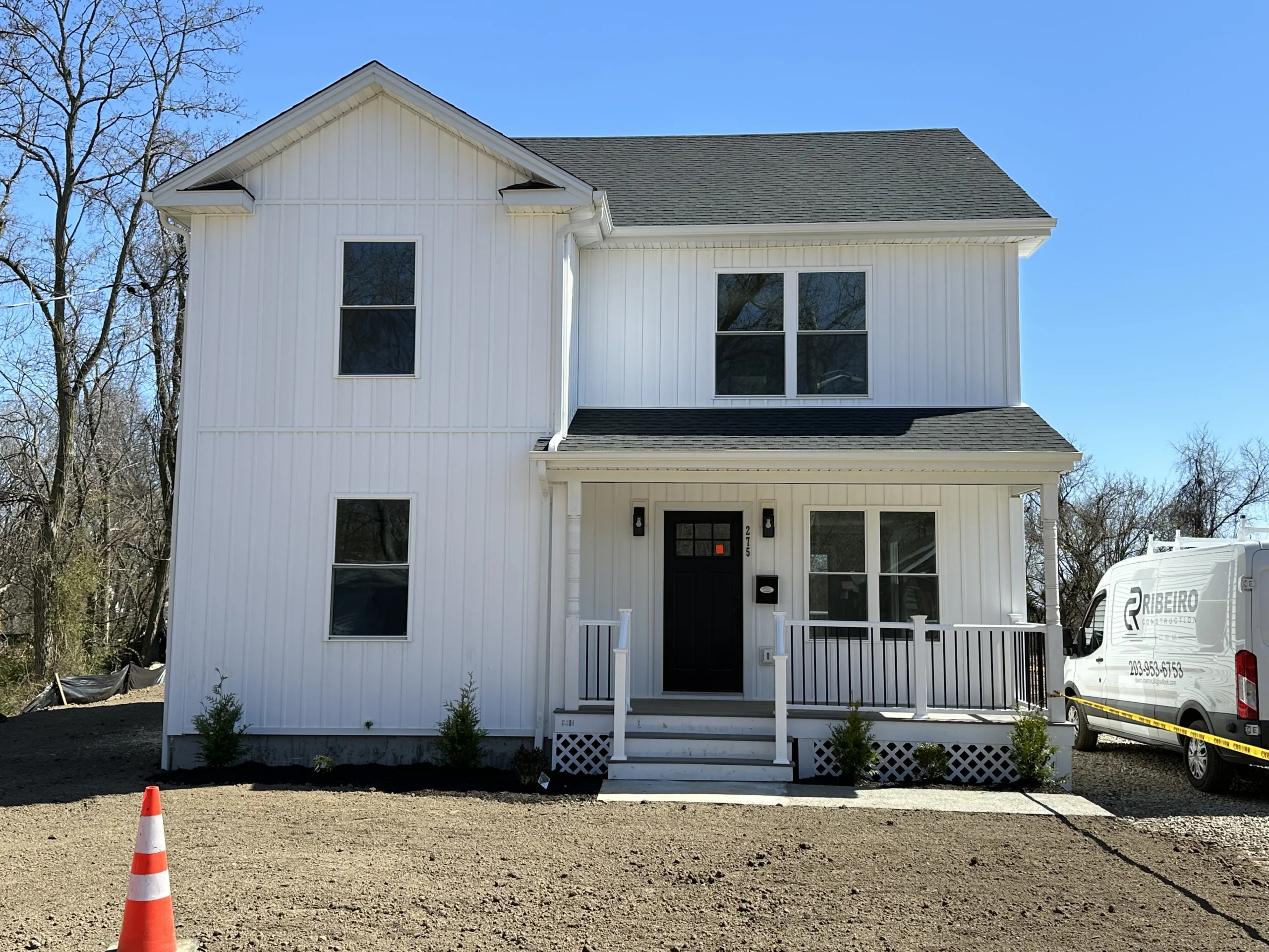 Window replacement and door installation by Ribeiro Construction, enhancing home exterior.